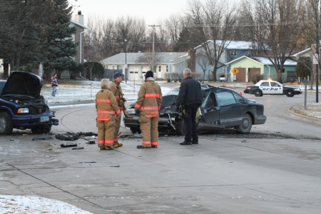 Grand_Forks_auto_accident_no_3259_450x300 Car accident scene with firefighters and police officer standing nearby