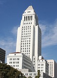 View of the LA City Hall skyscraper under a blue sky
