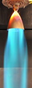 Test firing of rocket engine with blue flames