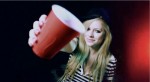 Avirl holding red cup at camera